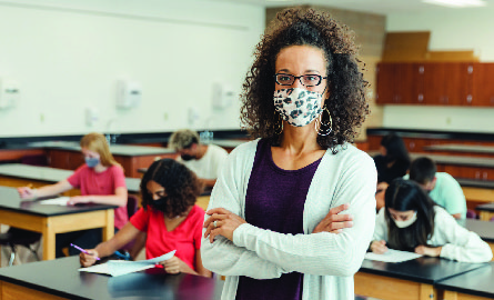 Teacher wearing a mask in a classroom