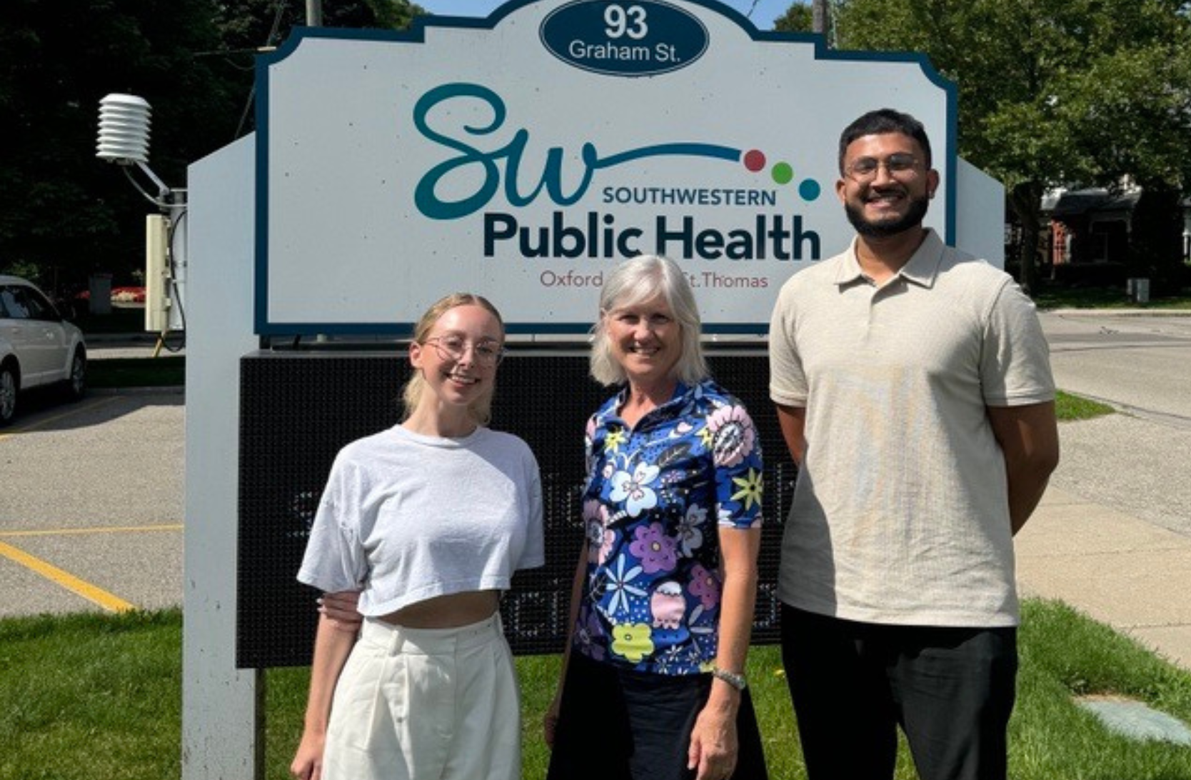 Students in front of a sign