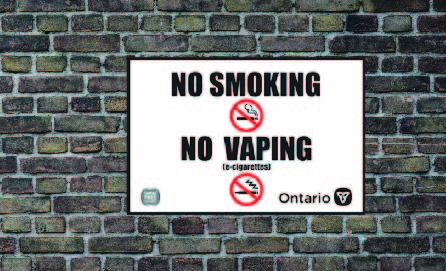 No smoking vaping sign on brick wall
