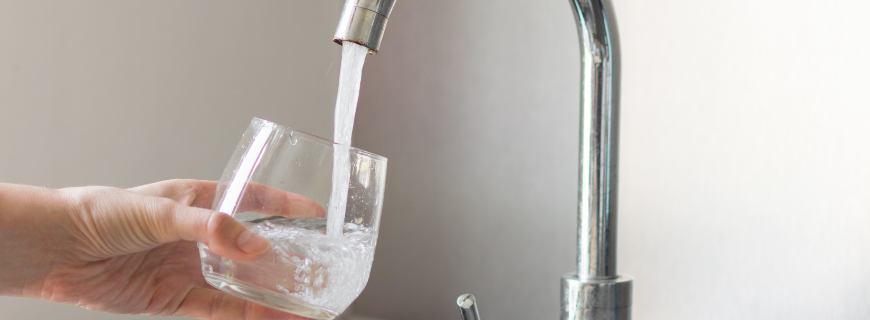 Tap water filling a drinking glass