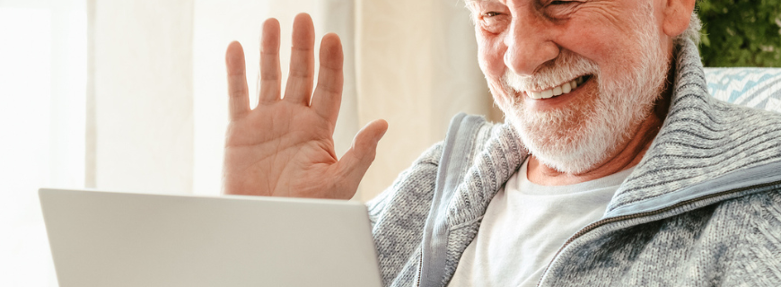 Picture of a man in his 70s, waving to someone on the screen.