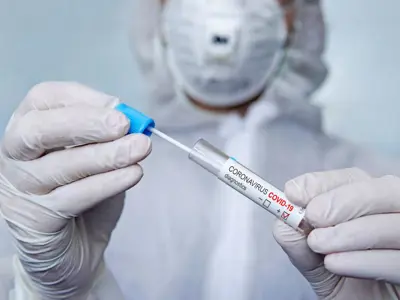 Health care provider preparing a needle for vaccination