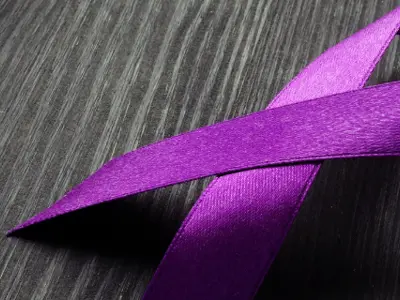 Picture of purple ribbon representing loss of life due to overdose