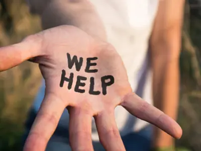 Picture of an outstretched hand with the words "we help"