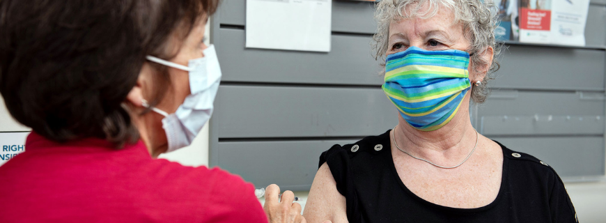 Older woman being vaccinated