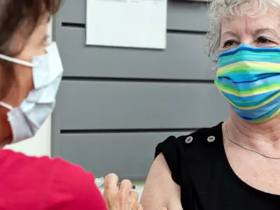 Older woman being vaccinated