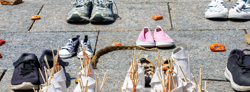 Photos of pairs of shoes. Each represents a child lost to the Indian Residential School System